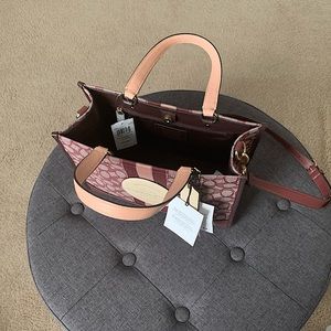 Brand new Coach Dempsey Bag Wine Color. comes with Coach dust bag for storage.